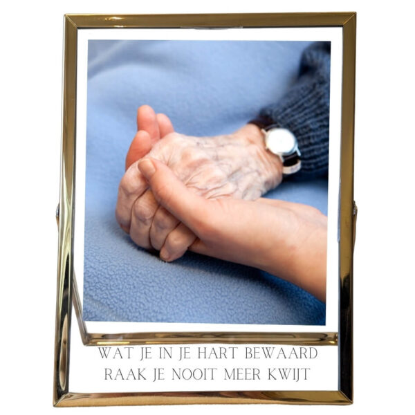 Een gouden fotolijst met daarin een foto, onder de foto staat een opdruk van de tekst: wat je in je hart bewaard, raak je nooit meer kwijt.
