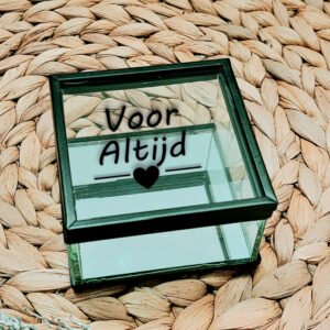 Vierkant glazen kistje met zwart frame en een opdruk: "Voor altijd" met daar onder een lijn welke onderbroken is door een hartje